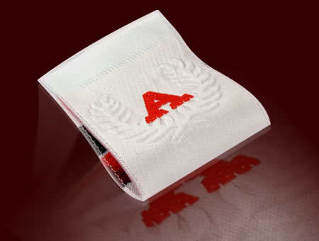 Embossed woven labels